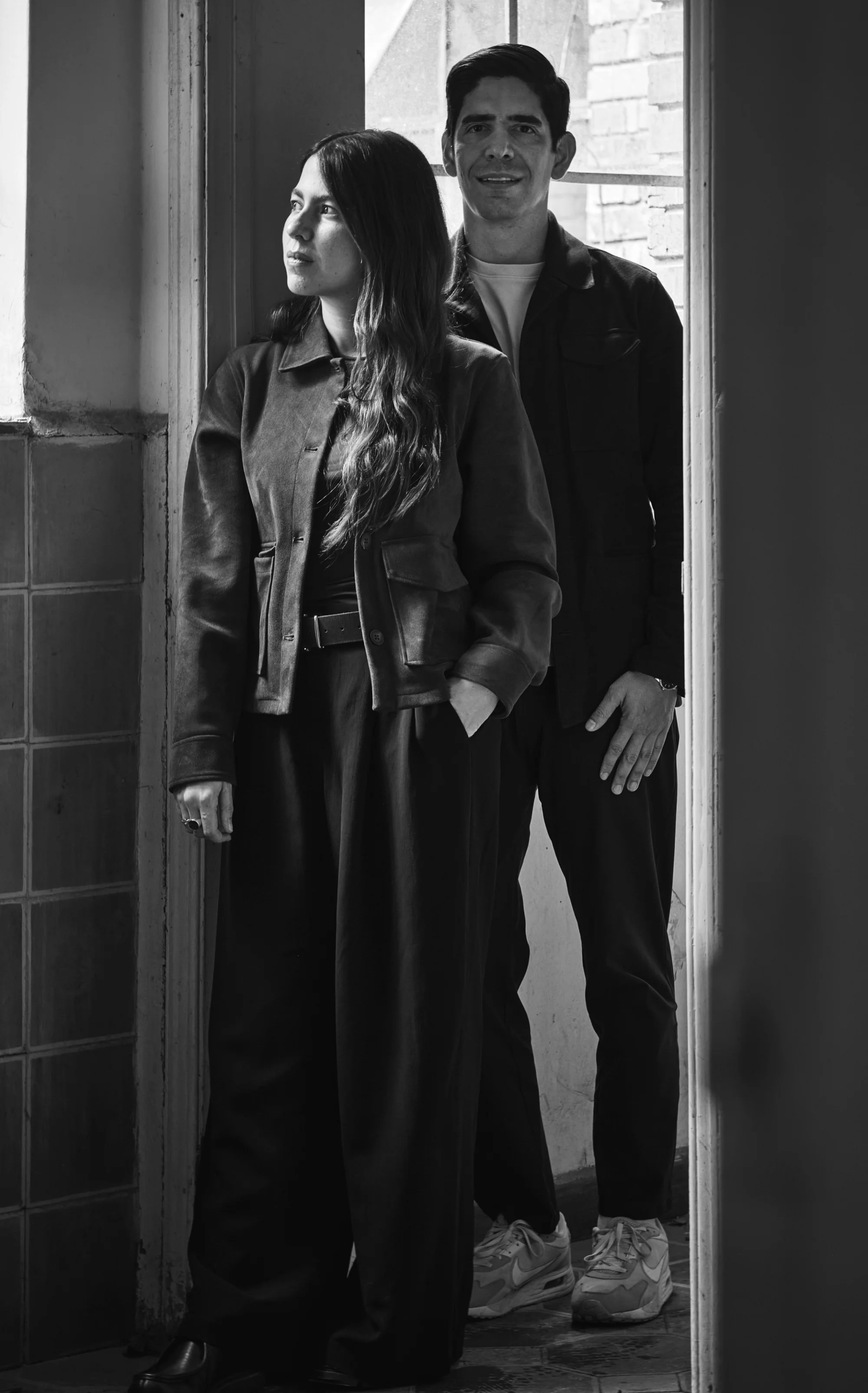 Miguel León Borda y María Adelaida Herrera, socios fundadores de CrearQ, retratados en blanco y negro junto a un ventanal