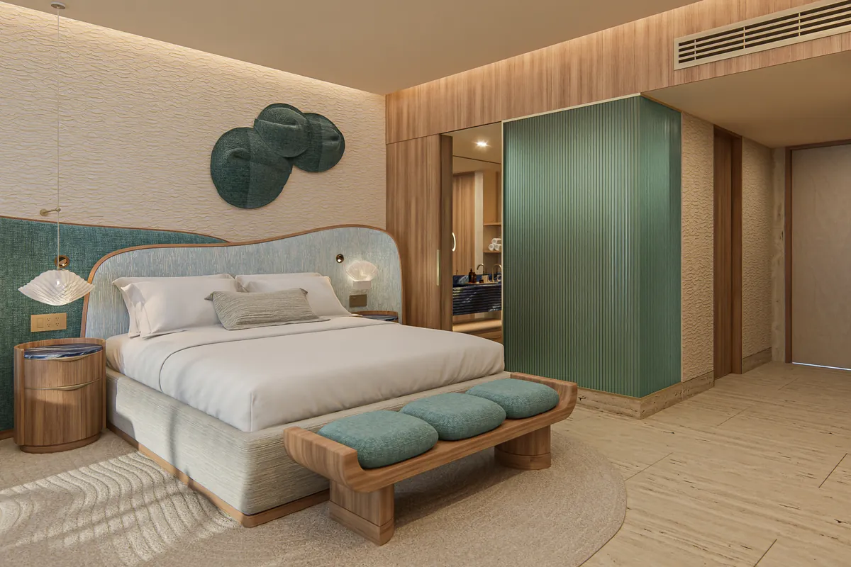Habitación con cabecera tapizada en verde salvia, banca al pie de la cama y arte de espejo con forma de coral en la pared
